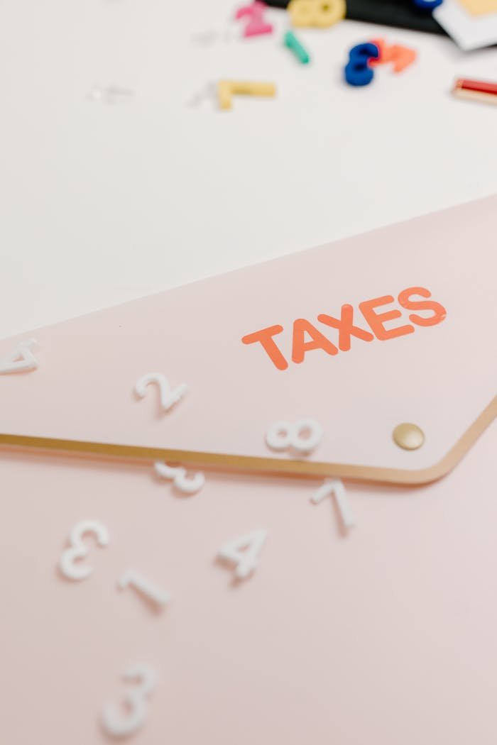 Mastering the First Impression: Your intriguing post title goes here A conceptual image of a pink envelope labeled Taxes with scattered numbers, symbolizing tax calculations.
